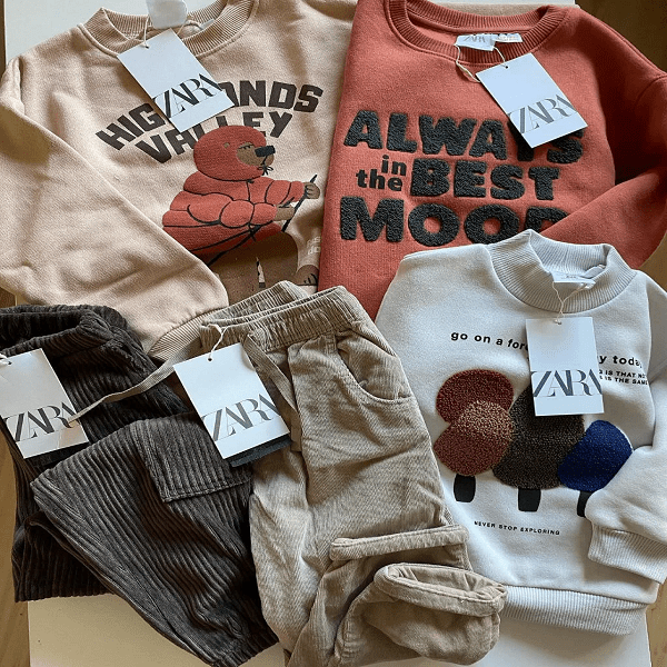 Zara Kids Wholesale Clothing Pallets stacked with assorted children’s apparel, bulk fashion lots for resale and retail inventory.